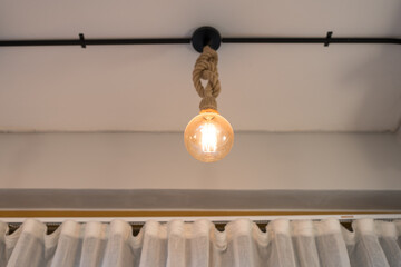 A beautifully styled hanging light bulb emits a warm glow