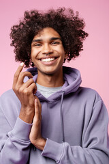 Smiling young man with curly hair wearing hoodie