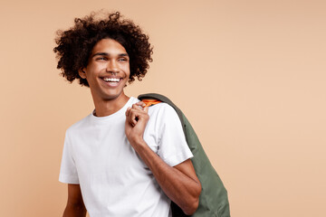 Young man smiling, looking aside with curly hair