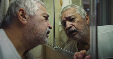Older man touching mirror with a pensive expression, lost in thought, a poignant and dramatic moment of emotional self-reflection and deep introspection