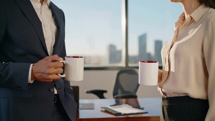 Professionals clinking coffee mugs in office