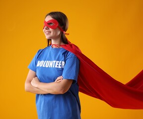 Volunteer wearing superhero costume on yellow background