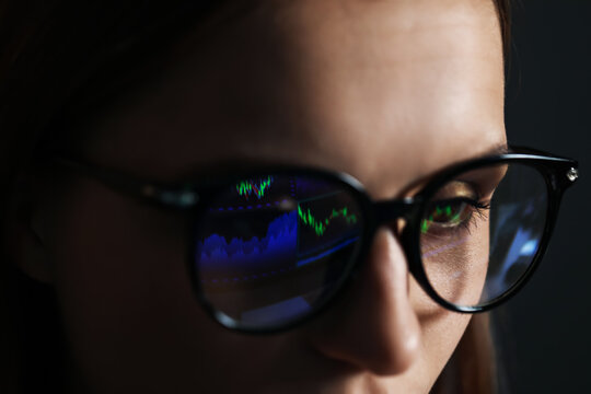 Young woman wearing glasses with reflection on dark background, closeup - Powered by Adobe