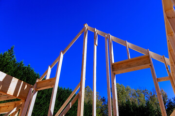 Construction workers build wooden frame is beams of house under progress craftsmanship.