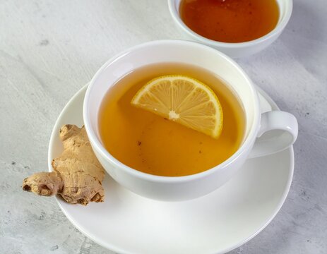 Cup of Hot Ginger Tea with Lemon Slice and Honey for Premium Herbal Drink Object and Healthy Beverage Concept