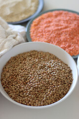 Bowls and bags full of various healthy grains and legumes. Selective focus.
