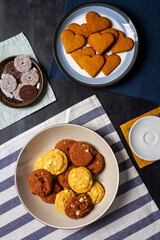 Bowl and plates with cookies on black chalkboard texture. Flat lay. Top view. Food concept.