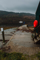 Strontian Jetty and slipaway extending into the tranquil waters of Loch Sunart, Scottish Highlands, on a peaceful day