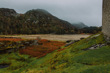 A dramatic and atmospheric photograph of the ruined medieval Castle Tioram (pronounced "Cheerum"), the former stronghold of the Clanranald branch of the MacDonalds - in Loch Moidart