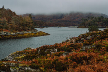 A dramatic and atmospheric photograph of the ruined medieval Castle Tioram (pronounced "Cheerum"), the former stronghold of the Clanranald branch of the MacDonalds - in Loch Moidart