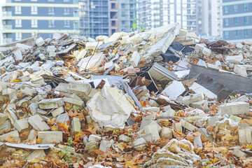 Remains of demolished structures in front of newly built high-rise blocks. Symbol of economic...