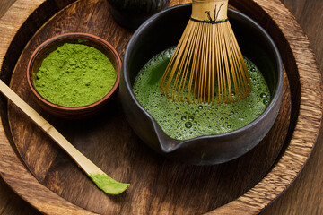 Traditional Matcha Preparation. High-angle view of matcha tea being prepared with a bamboo whisk