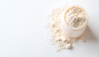 Fine white powder spills from clear container, creating soft, textured surface. scene evokes sense of purity and simplicity