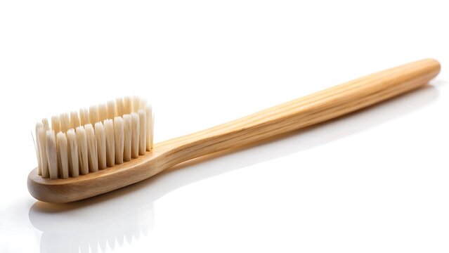 Natural bamboo toothbrush with white bristles isolated on a clean white background natural toothbrush - Powered by Adobe