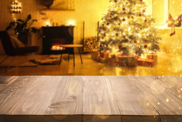 Empty wooden table in room decorated for Christmas, bokeh lights. Space for design