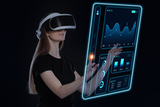 Woman using digital screen with data via virtual reality headset on black background. Innovative technology for business