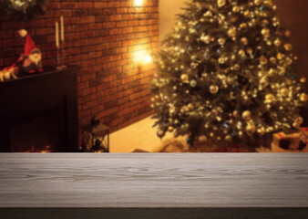 Empty wooden table in room decorated for Christmas. Space for design
