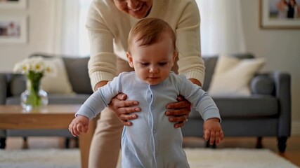 Grandmother assisting baby with first steps in cozy living room