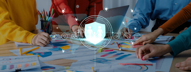 A diverse team engages in a collaborative discussion about data security strategies. The scene features charts and visual aids, emphasizing teamwork and digital protection. Trope