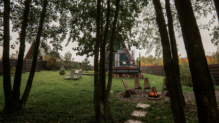 Cozy A-frame cabin with a fire pit in a peaceful forest setting