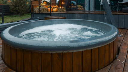 Relaxing outdoor hot tub with bubbling water on a wooden deck