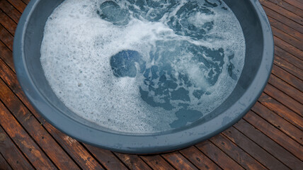 Bubbling water in a round tub on a wooden deck