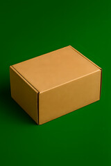 A closed cardboard box on a green background