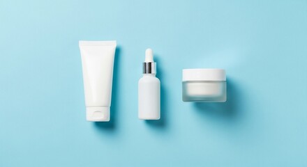 Cosmetic products arranged neatly on a light blue surface, showcasing skincare essentials for a minimalist and clean beauty routine.