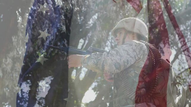Soldier adjusting gun stance as transparent flag fading and scanning treetops in military training