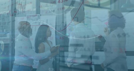 Four-person team analyzing business data charts after woman placing red sticky note on glass wall - Powered by Adobe