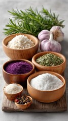 Fototapeta premium Rustic Still Life Food Photography Featuring Wooden Bowls Filled With Various Salts and Spices Garnished With Fresh Rosemary and Garlic Cloves on a Textured Gray Surface