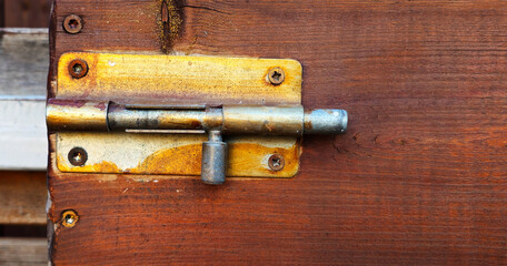 A bolt on a wooden door
bolt lock
