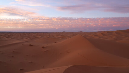 Fototapeta premium A trip to Sahara desert in Algeria. Beautiful african travel photo. Sandy landscapes, dunes, and nature. Summer vacation in arab country.