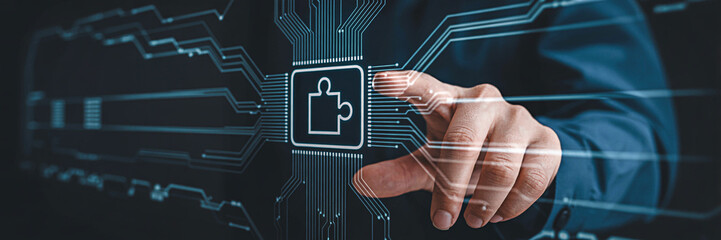 Man's hand interacts with a digital interface featuring a puzzle piece icon representing technology solutions and connectivity in a modern futuristic design