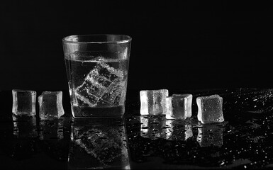 a glass of water with ice cubes