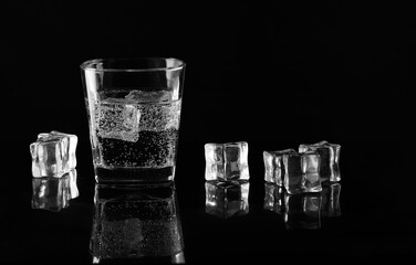 a glass of water with ice cubes