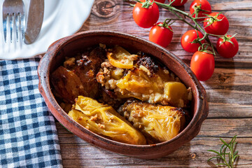 Traditional cabbage rolls (sarma) served in a rustic brown bowl, showcasing tender leaves stuffed with a savory meat and rice filling. The warm, hearty dish is highlighted by natural lighting, emphasi