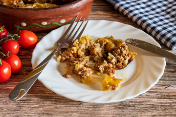Traditional stuffed cabbage rolls (sarma) served on a plate, featuring tender cabbage leaves wrapped around a savory meat and rice filling. The warm, hearty dish is presented simply, highlighting its 