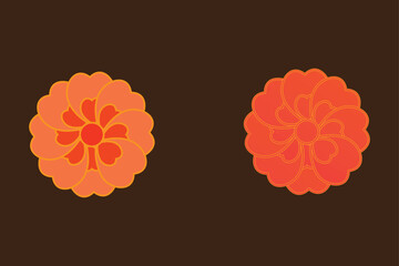 Two orange floral patterned cookies on a dark background