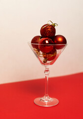 Red Christmas baubles in a martini glass