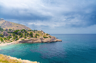 Cala Almadraba Cove beach in Benidorm bay Mediterranean Sea azure turquoise water, Costa Blanca coastline coast in Serra Gelada natural park in summer day, Valencian Community, Spain