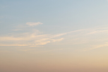 Serene sunset sky with soft pastel clouds and gentle horizon