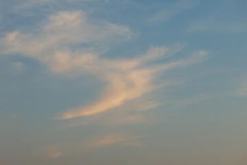 Tranquil evening sky with soft wispy clouds at sunset