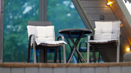 Outdoor patio seating with table and decorative pillows, perfect for relaxation