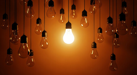 Illuminated light bulb surrounded by unlit bulbs, concept of standing out