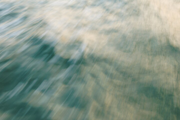 Abstract blurred ocean waves with sunlight reflections