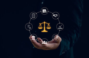 Legal and compliance concept with businessman hand holding digital icons of law, justice, agreement, and regulation. Corporate governance, contract management, and business ethics in technology.