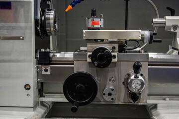 Close-up of a modern industrial metalworking machine, highlighting its precise mechanical components, controls, and robust construction. Ideal for manufacturing, engineering, and technology themes.