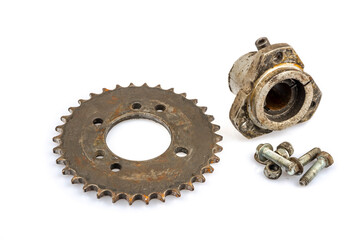Close up of dirty, oily and greasy old motorcycle chain and sprocket set on white background. The image reflects the essence of repair, maintenance