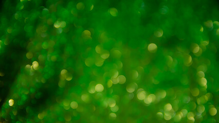 Green glow. Abstract background. Light and bokeh. Abstraction circles on a black background.